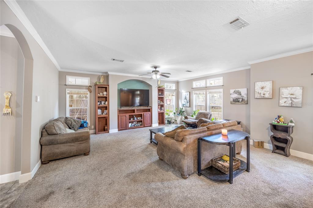 1085 State Rte 100 Florahome, FL 32140 - Photo 9 of 52 a living room with furniture and a flat screen tv
