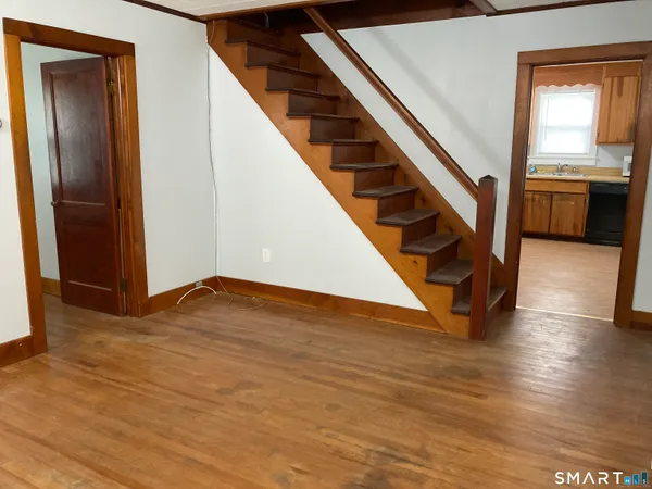 a view of an entryway with wooden floor and stairs