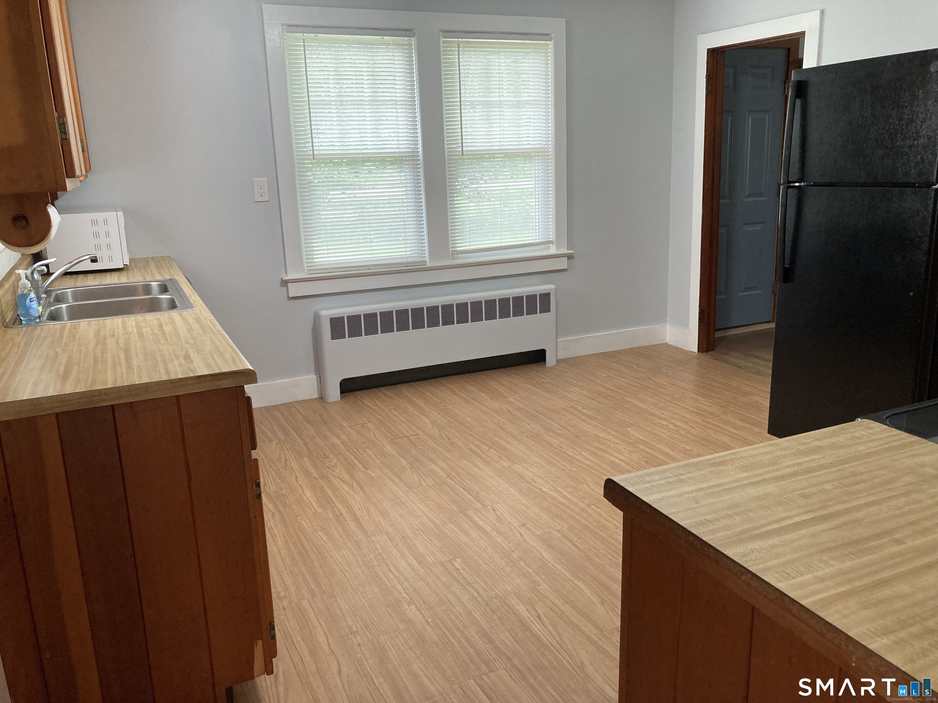 282 Norwich-Westerly Road Preston, CT 06365 - Photo 11 of 11 a kitchen with a wooden floor and a sink