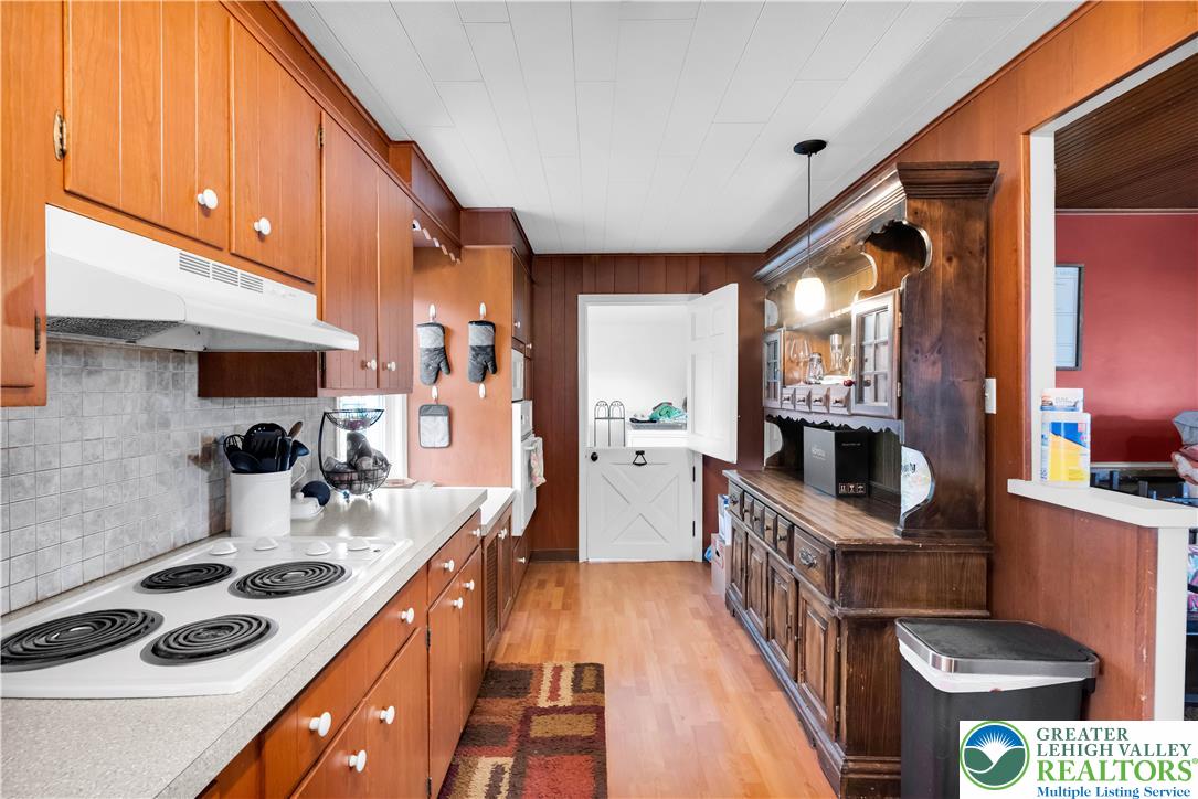7281 Decatur Street New Tripoli, PA 18066 - Photo 9 of 24 a kitchen with stainless steel appliances a stove a sink dishwasher and cabinets with wooden floor
