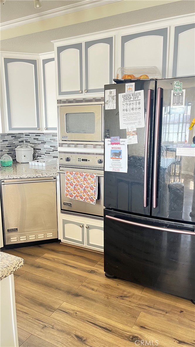 14515 Rivers Edge Road Helendale, CA 92342 - Photo 13 of 24 a kitchen with stainless steel appliances granite countertop a refrigerator and a stove
