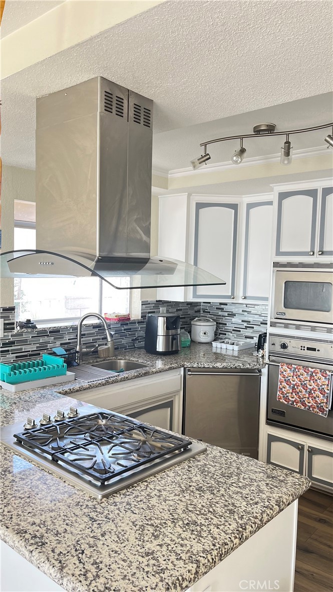 14515 Rivers Edge Road Helendale, CA 92342 - Photo 15 of 24 a kitchen with stainless steel appliances granite countertop a sink and cabinets