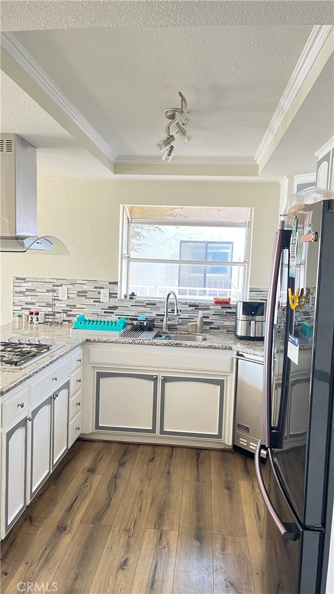 14515 Rivers Edge Road Helendale, CA 92342 - Photo 16 of 24 a view of a kitchen with granite countertop window and a sink