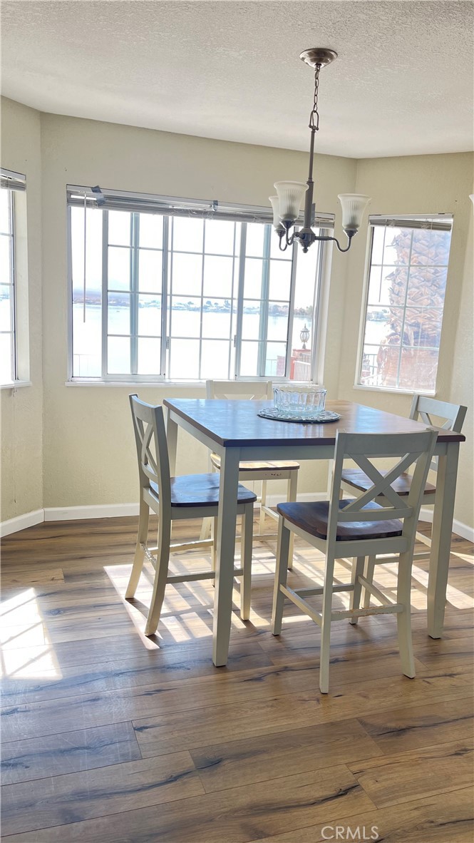14515 Rivers Edge Road Helendale, CA 92342 - Photo 17 of 24 a view of a dining room with furniture window and wooden floor