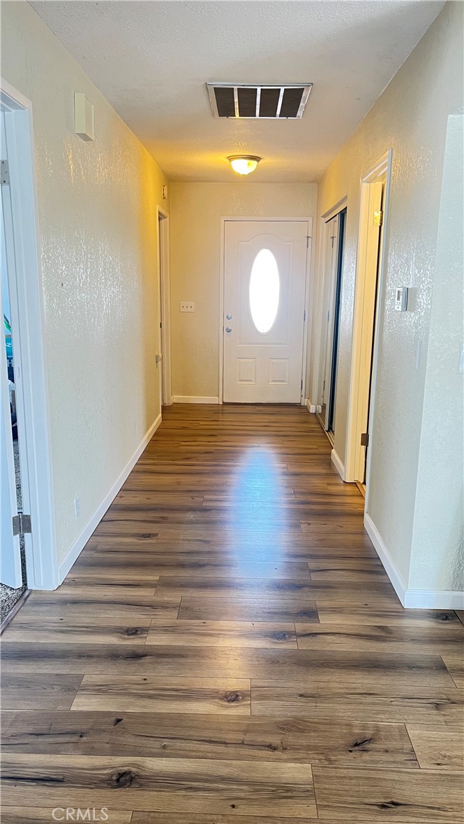 14515 Rivers Edge Road Helendale, CA 92342 - Photo 22 of 24 a view of empty room with wooden floor