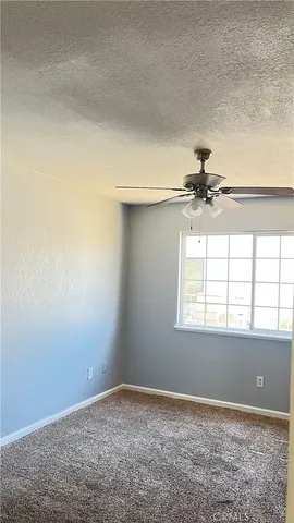 a view of a room with a ceiling fan