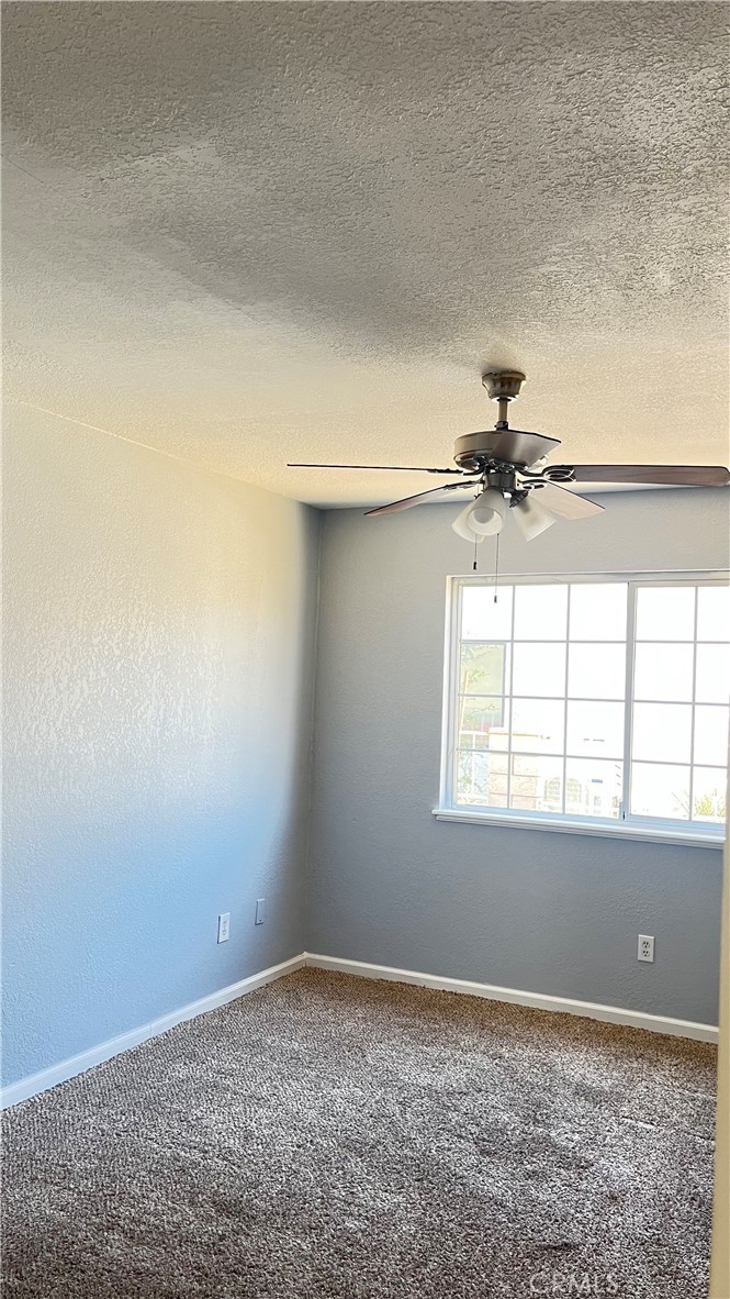14515 Rivers Edge Road Helendale, CA 92342 - Photo 10 of 24 an empty room with windows and fan