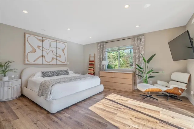 a bedroom with a large bed and a large window