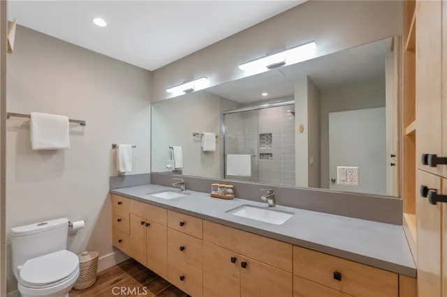 a bathroom with a granite countertop sink mirror and toilet