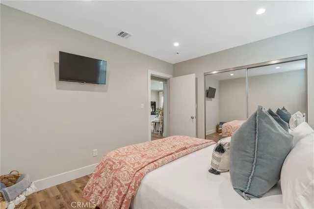 a bedroom with a bed and a television