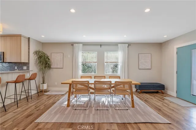 a kitchen with stainless steel appliances a dining table chairs and granite counter tops