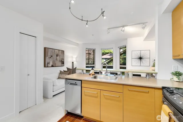 a kitchen with stainless steel appliances a sink stove and refrigerator