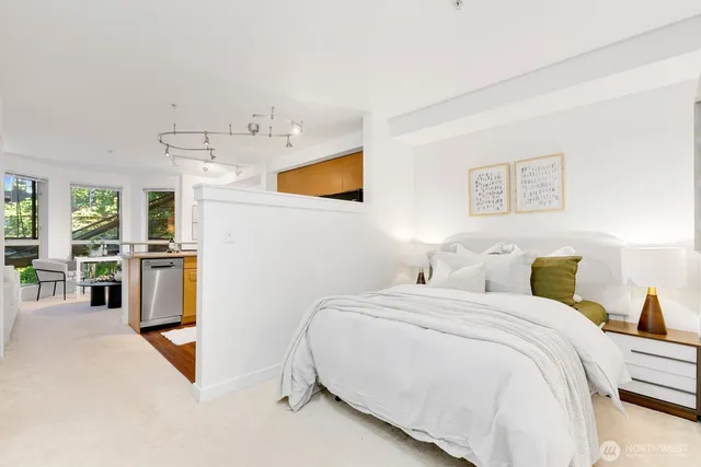 a bedroom with a bed and cabinets