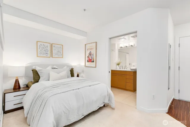 a bedroom with a bed a couch and dresser