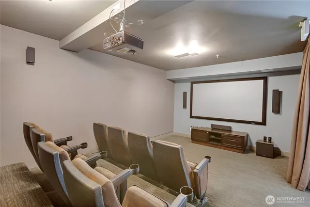 a room with furniture and projector and screen