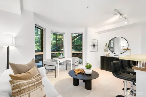 a living room with fireplace furniture and a large window