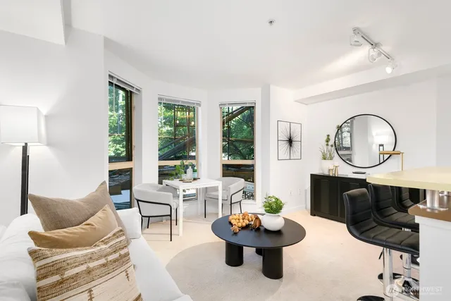 a living room with fireplace furniture and a large window