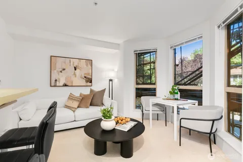 a living room with furniture and a potted plant
