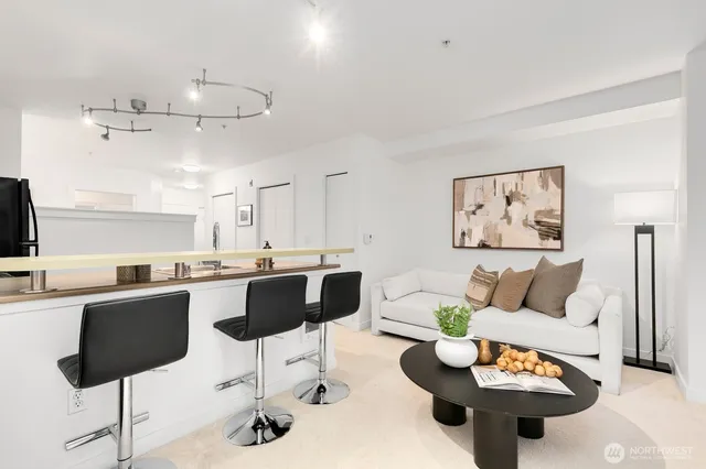 a living room with furniture and kitchen view