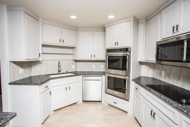 a bathroom with a sink and cabinets