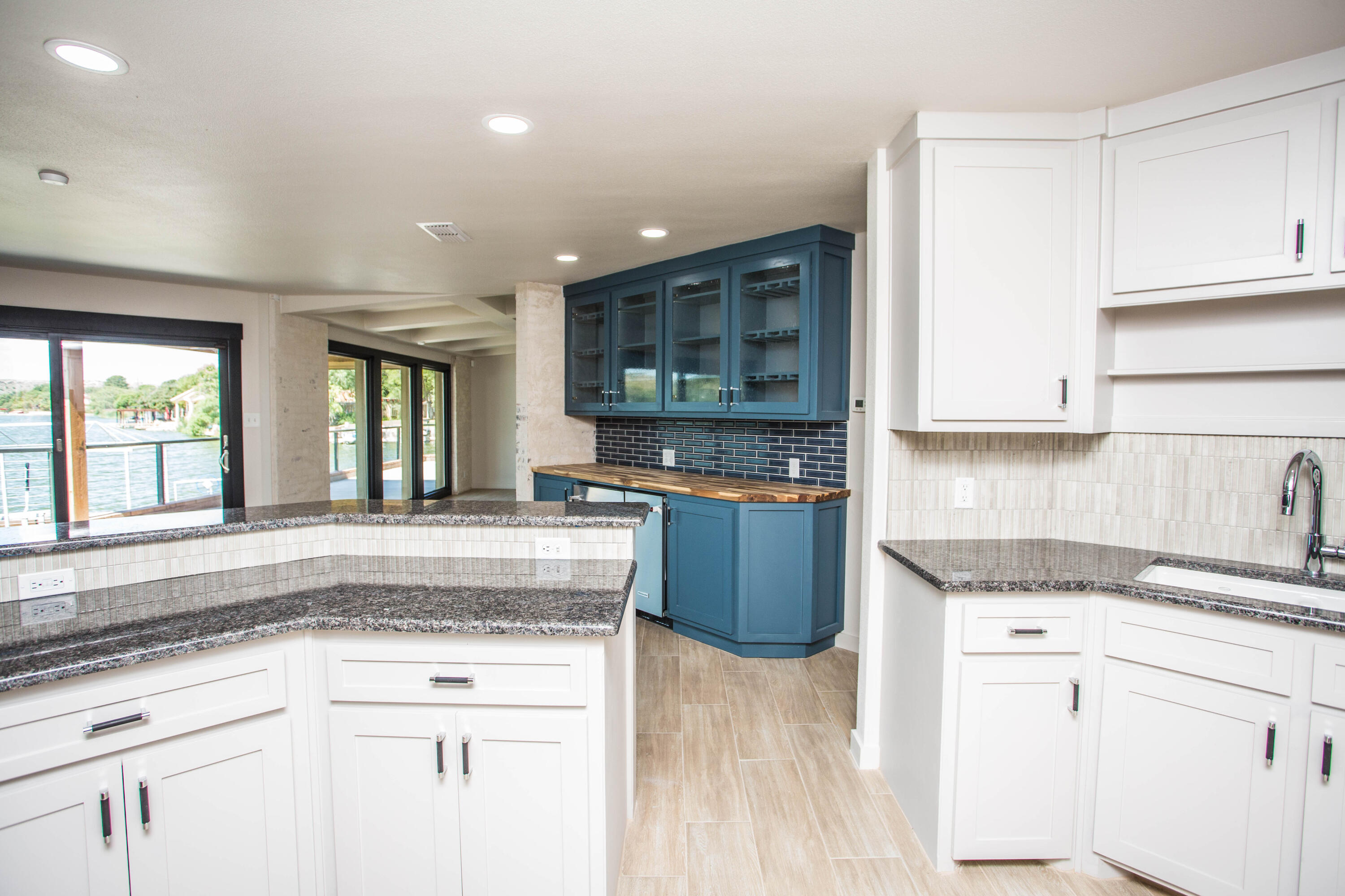 25 East Lakeshore Drive Ransom Canyon, TX 79366 - Photo 13 of 63 a kitchen with granite countertop a sink stainless steel appliances and cabinets