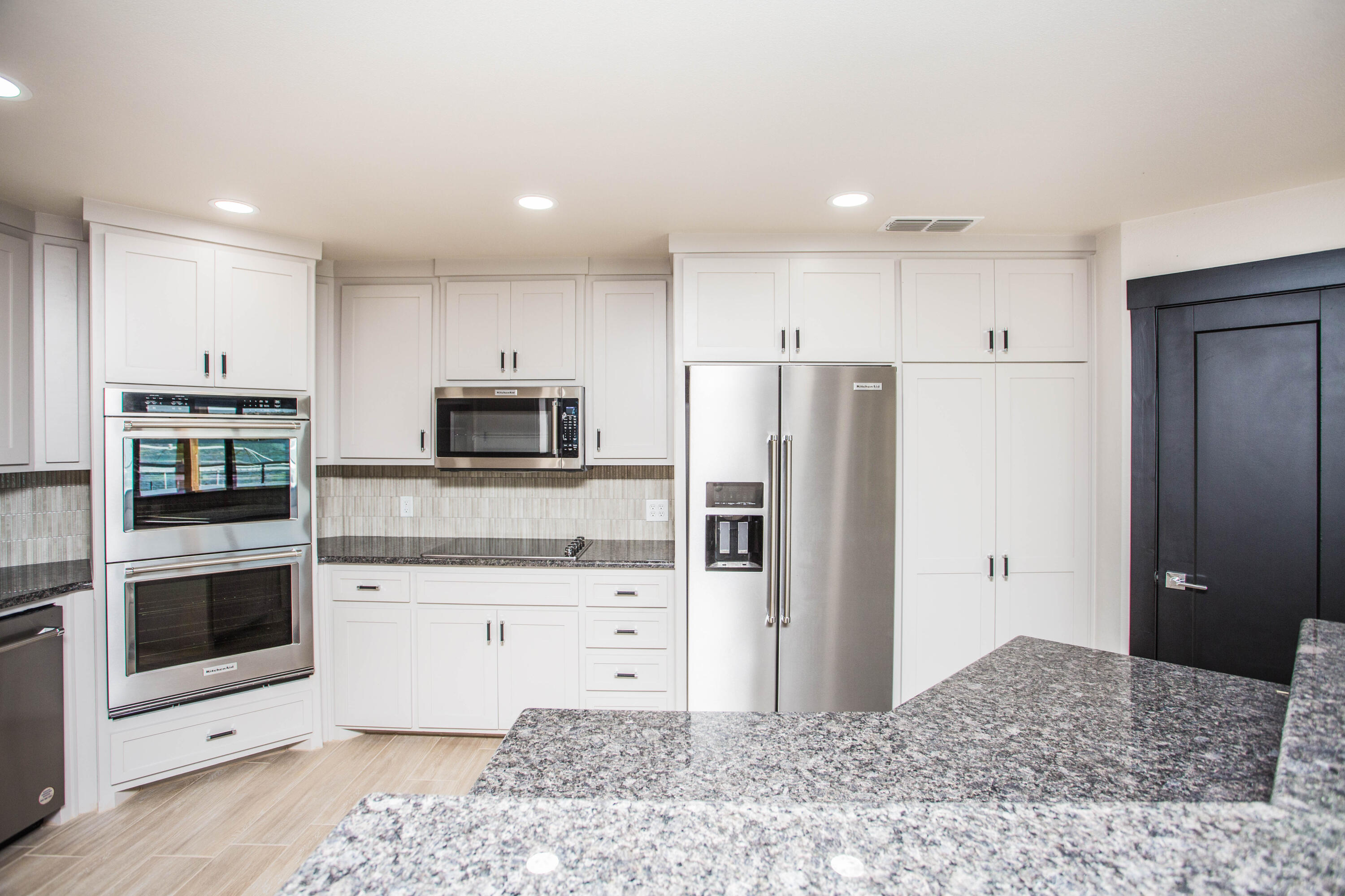 25 East Lakeshore Drive Ransom Canyon, TX 79366 - Photo 15 of 63 a kitchen with stainless steel appliances kitchen island granite countertop a refrigerator and a sink