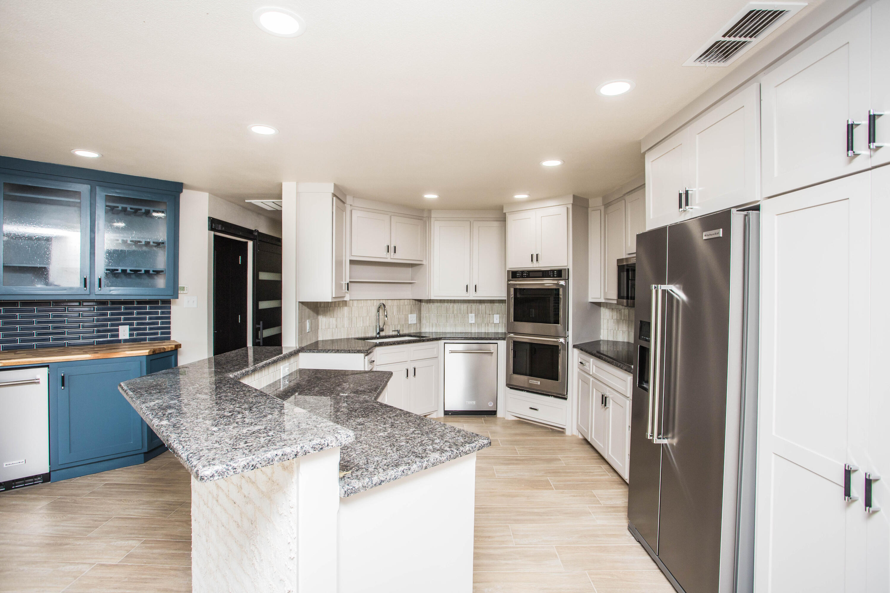 25 East Lakeshore Drive Ransom Canyon, TX 79366 - Photo 16 of 63 a kitchen with stainless steel appliances granite countertop a refrigerator and a sink