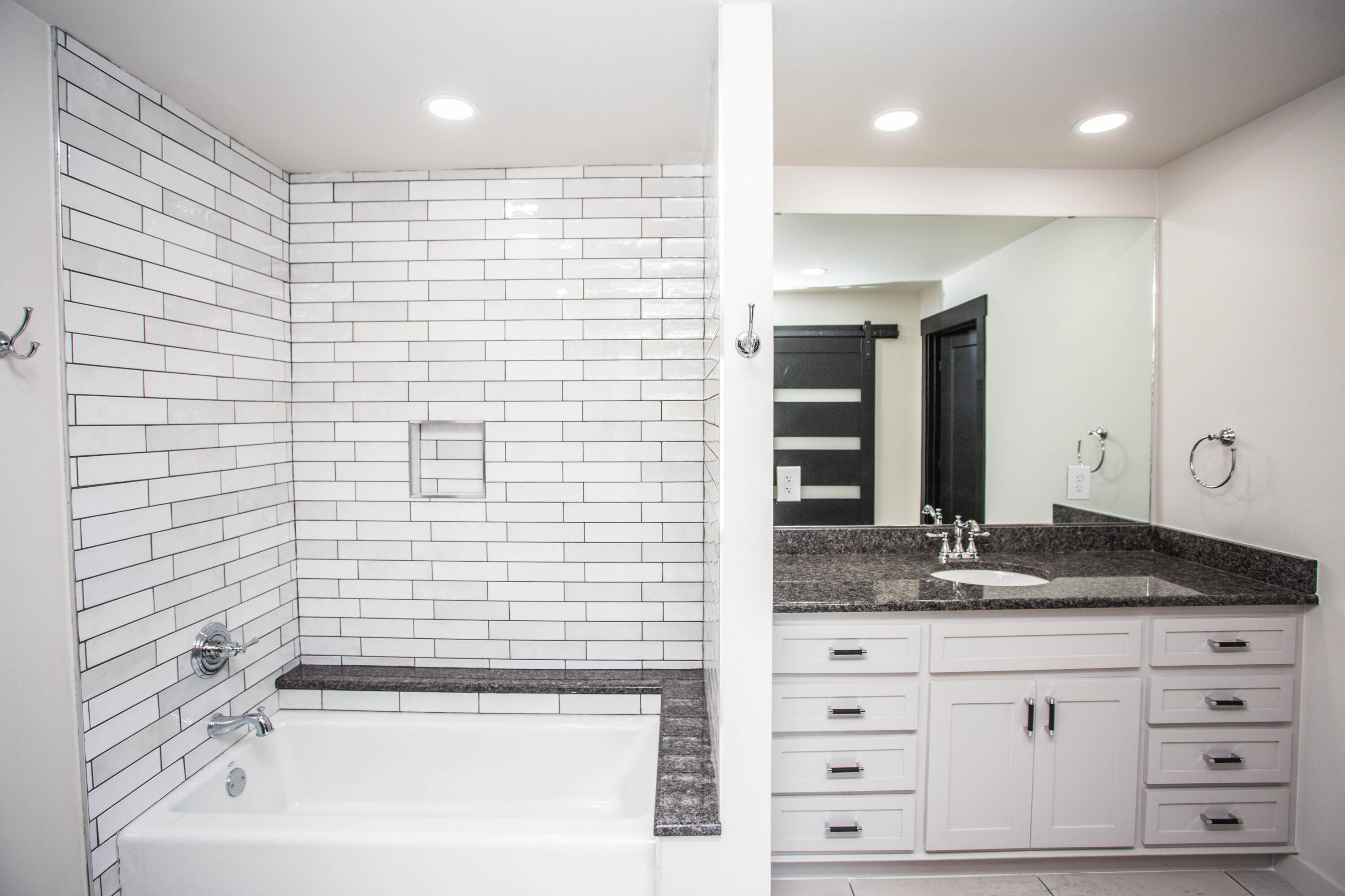 25 East Lakeshore Drive Ransom Canyon, TX 79366 - Photo 37 of 63 a bathroom with a granite countertop sink a vanity and a bathtub