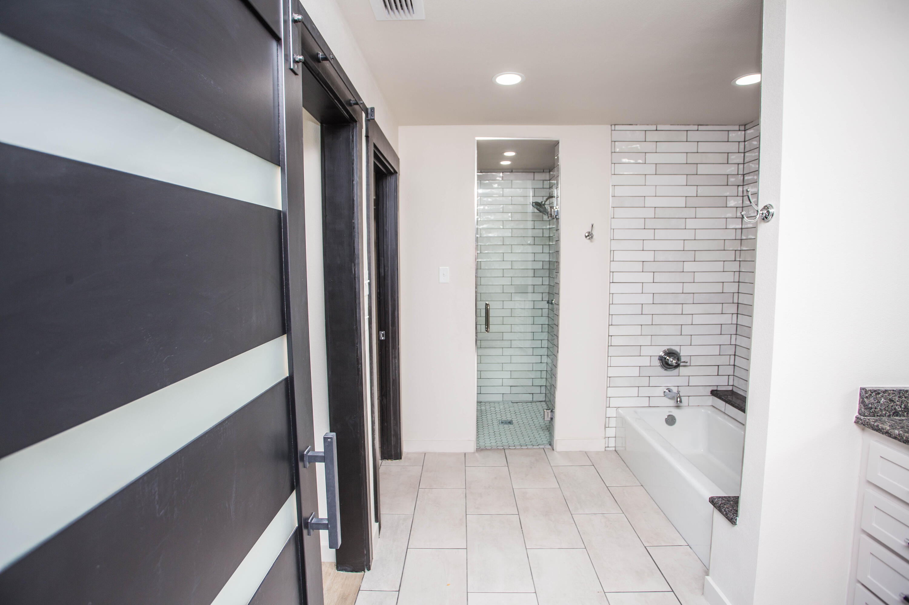 25 East Lakeshore Drive Ransom Canyon, TX 79366 - Photo 39 of 63 a bathroom with a bathtub and shower