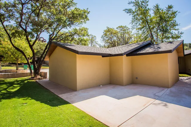 a kitchen with granite countertop a sink stainless steel appliances and cabinets