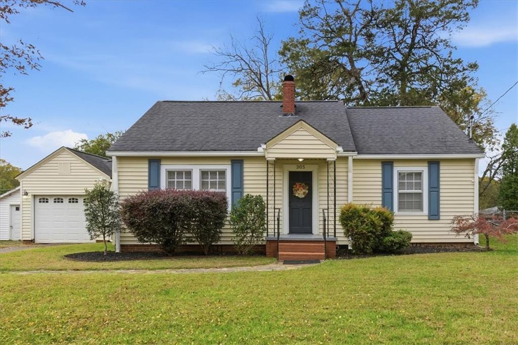 a front view of a house with a garden and porch