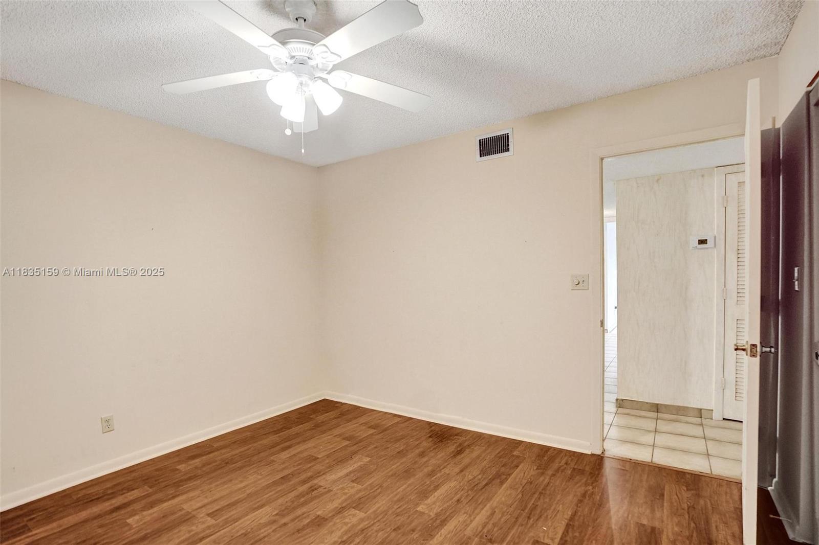 4965 East Sabal Palm Boulevard, Unit 207 Tamarac, FL 33319 - Photo 11 of 37 wooden floor in an empty room