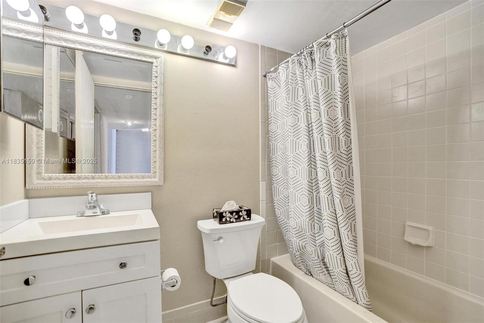 4965 East Sabal Palm Boulevard, Unit 207 Tamarac, FL 33319 - Photo 15 of 37 a bathroom with a sink a toilet and shower