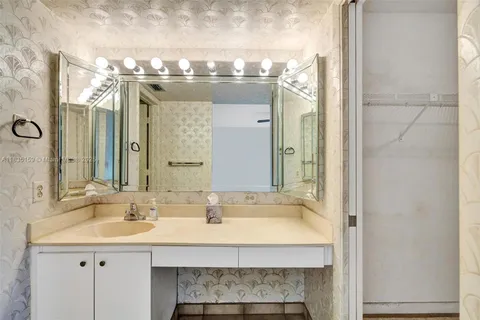 a bathroom with a sink a mirror and a shower