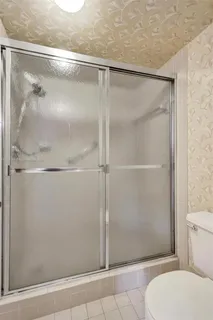 a bathroom with a glass shower door