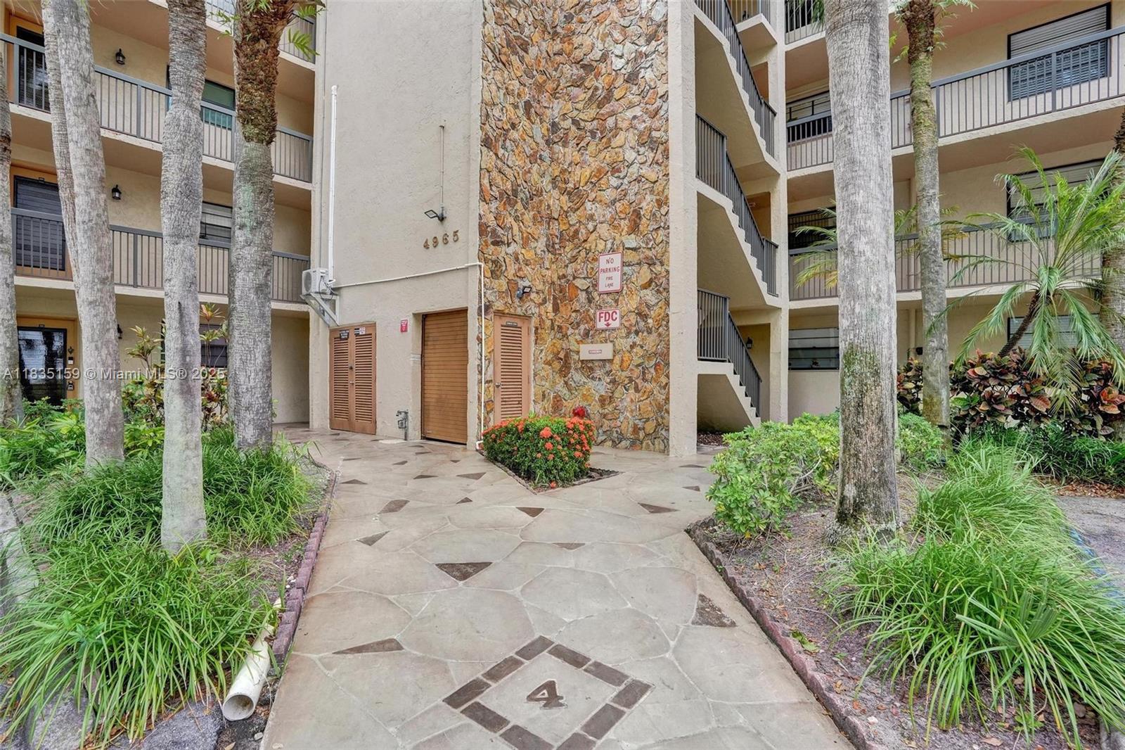 4965 East Sabal Palm Boulevard, Unit 207 Tamarac, FL 33319 - Photo 28 of 37 front view of a brick building