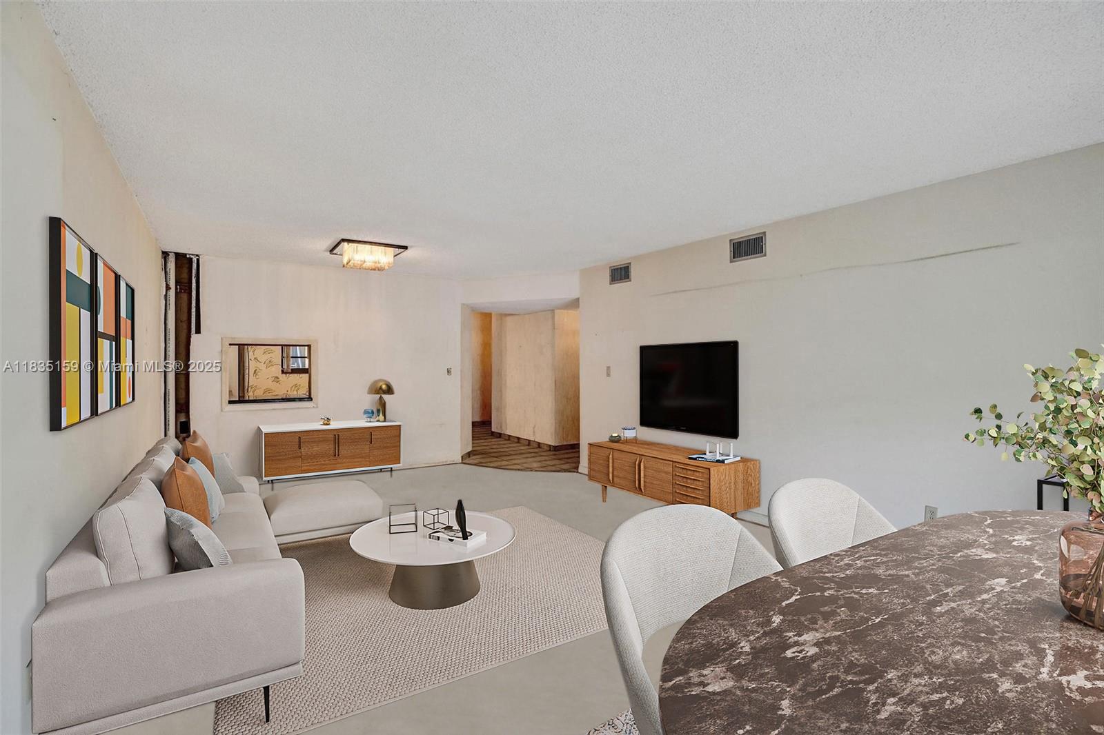 4965 East Sabal Palm Boulevard, Unit 207 Tamarac, FL 33319 - Photo 3 of 37 a living room with furniture and a flat screen tv