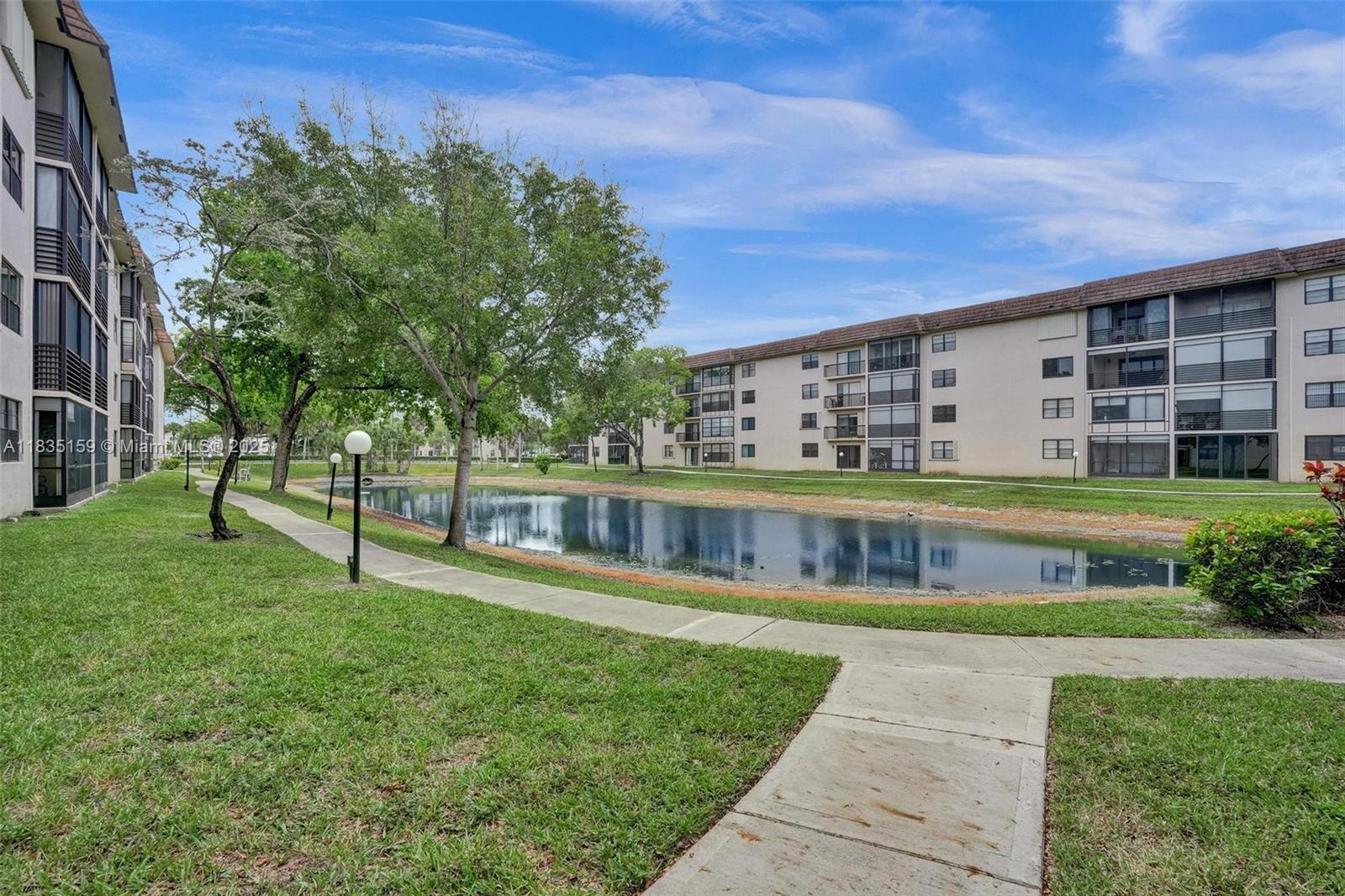 4965 East Sabal Palm Boulevard, Unit 207 Tamarac, FL 33319 - Photo 33 of 37 a view of a building with a yard