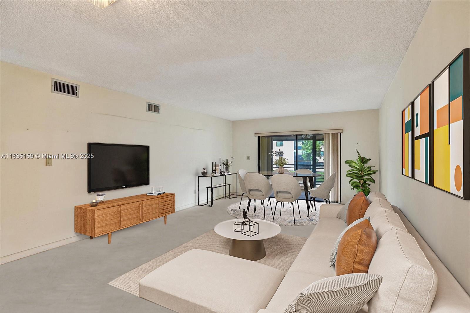 4965 East Sabal Palm Boulevard, Unit 207 Tamarac, FL 33319 - Photo 4 of 37 a living room with furniture and a flat screen tv