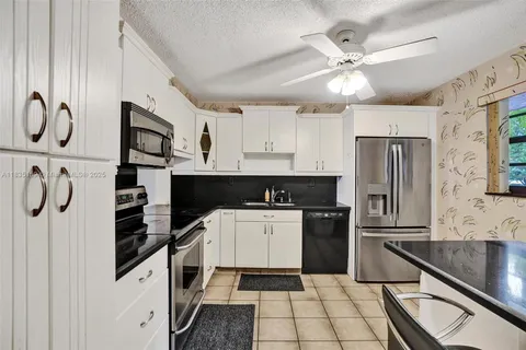 a kitchen with a refrigerator and a sink