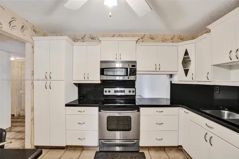 a kitchen with appliances cabinets and a counter space