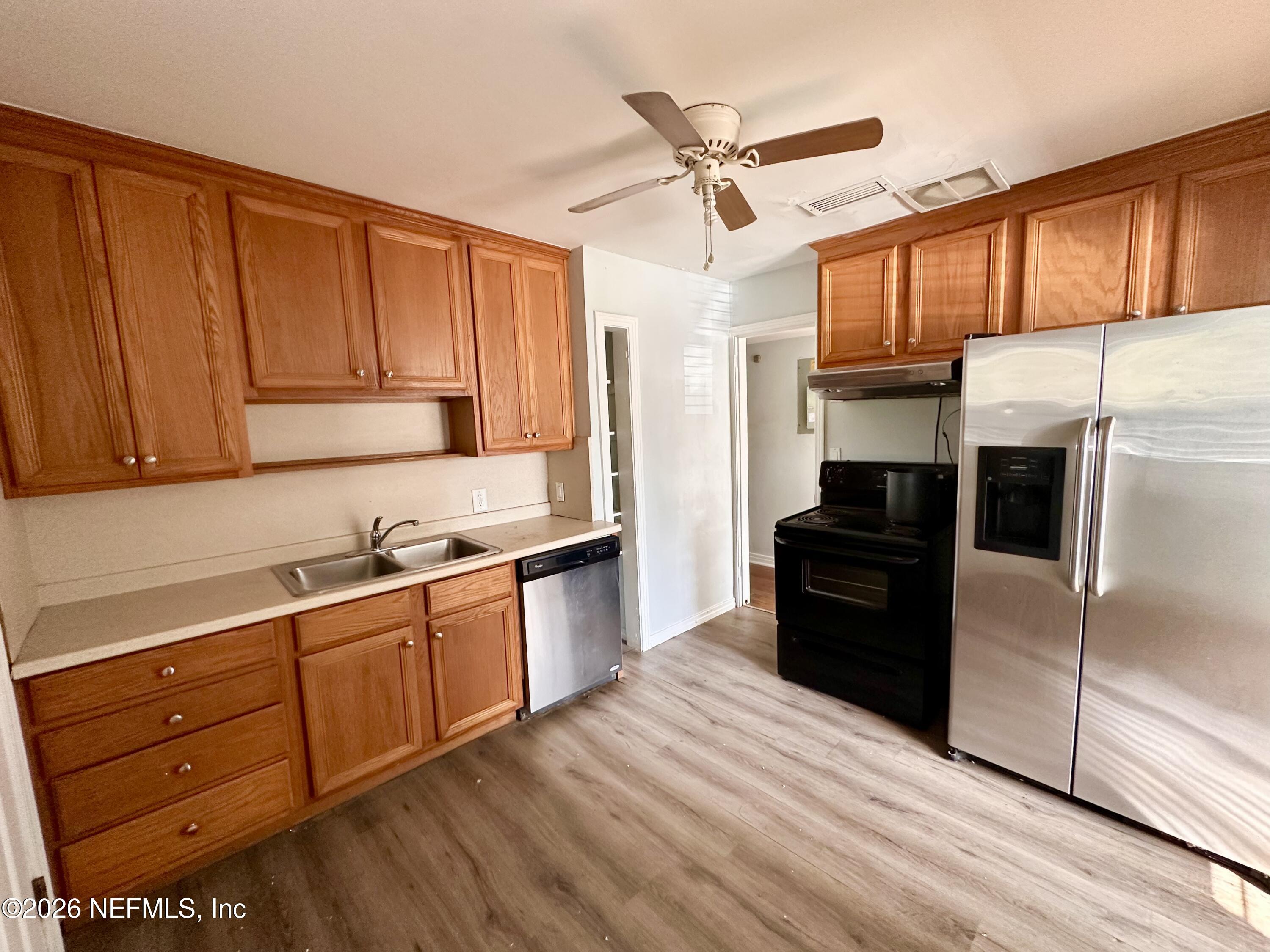 3638 Jammes Road Jacksonville, FL 32210 - Photo 12 of 31 a kitchen with granite countertop wooden cabinets and stainless steel appliances