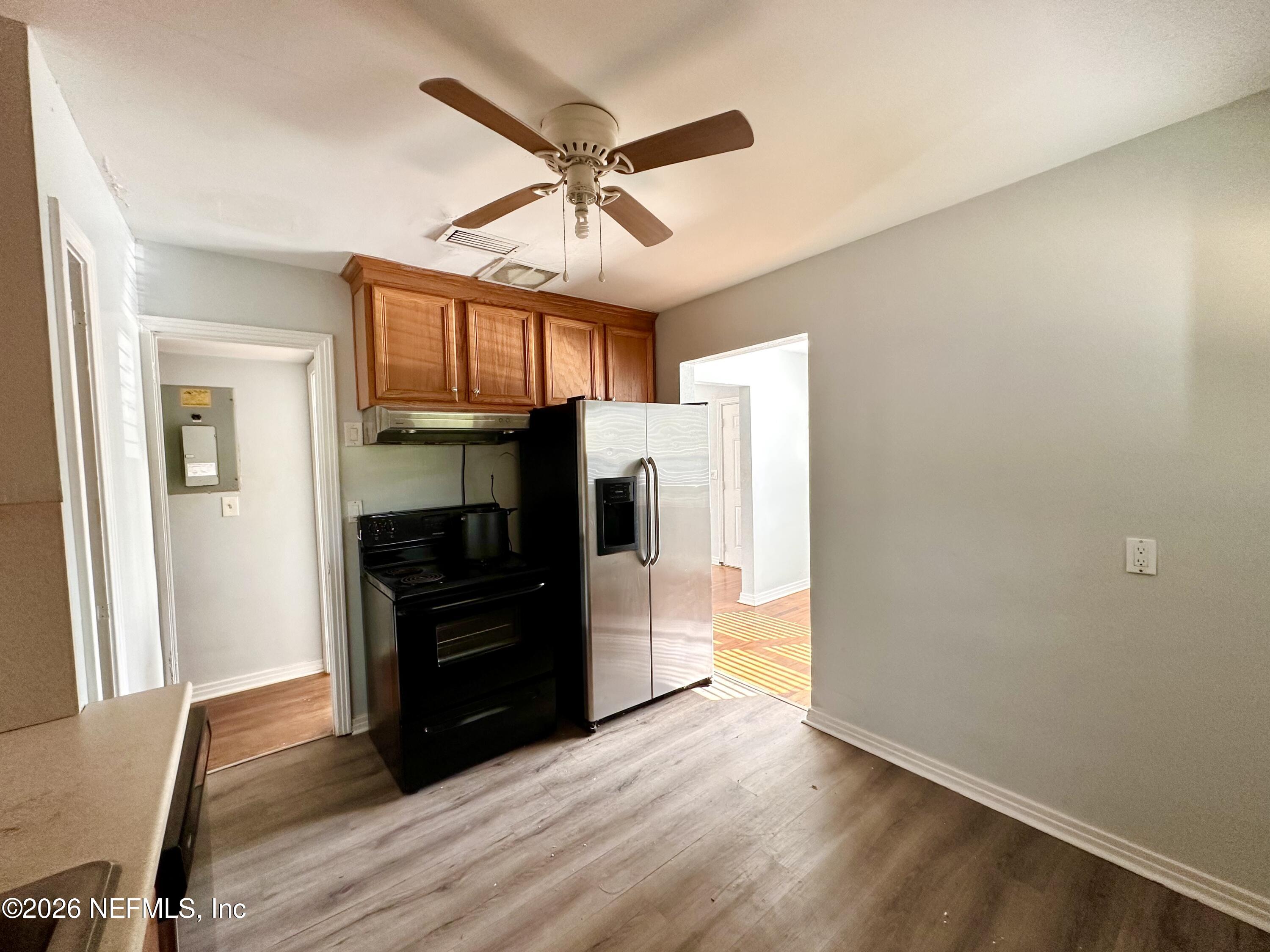 3638 Jammes Road Jacksonville, FL 32210 - Photo 13 of 31 a kitchen with a refrigerator and a stove top oven