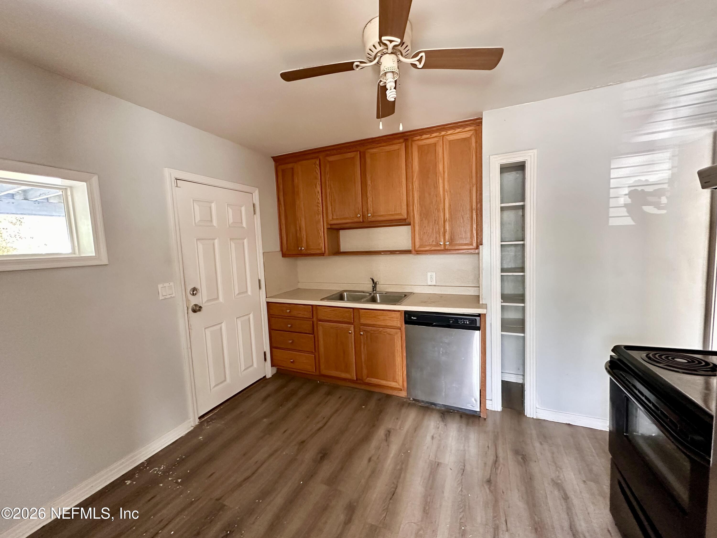3638 Jammes Road Jacksonville, FL 32210 - Photo 14 of 31 a kitchen with granite countertop a stove a sink and wooden floor