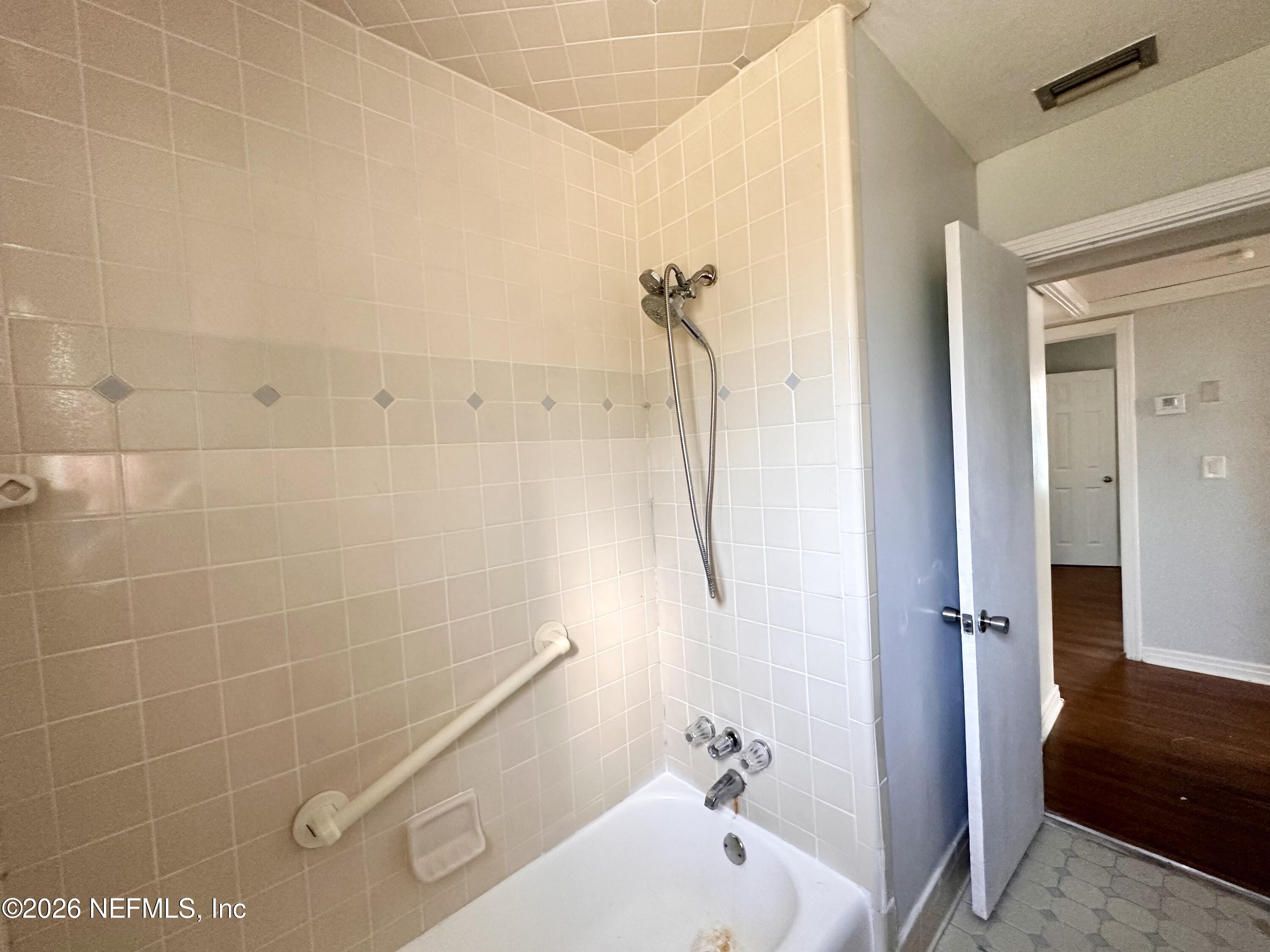 3638 Jammes Road Jacksonville, FL 32210 - Photo 16 of 31 a bathroom with a bathtub and a shower