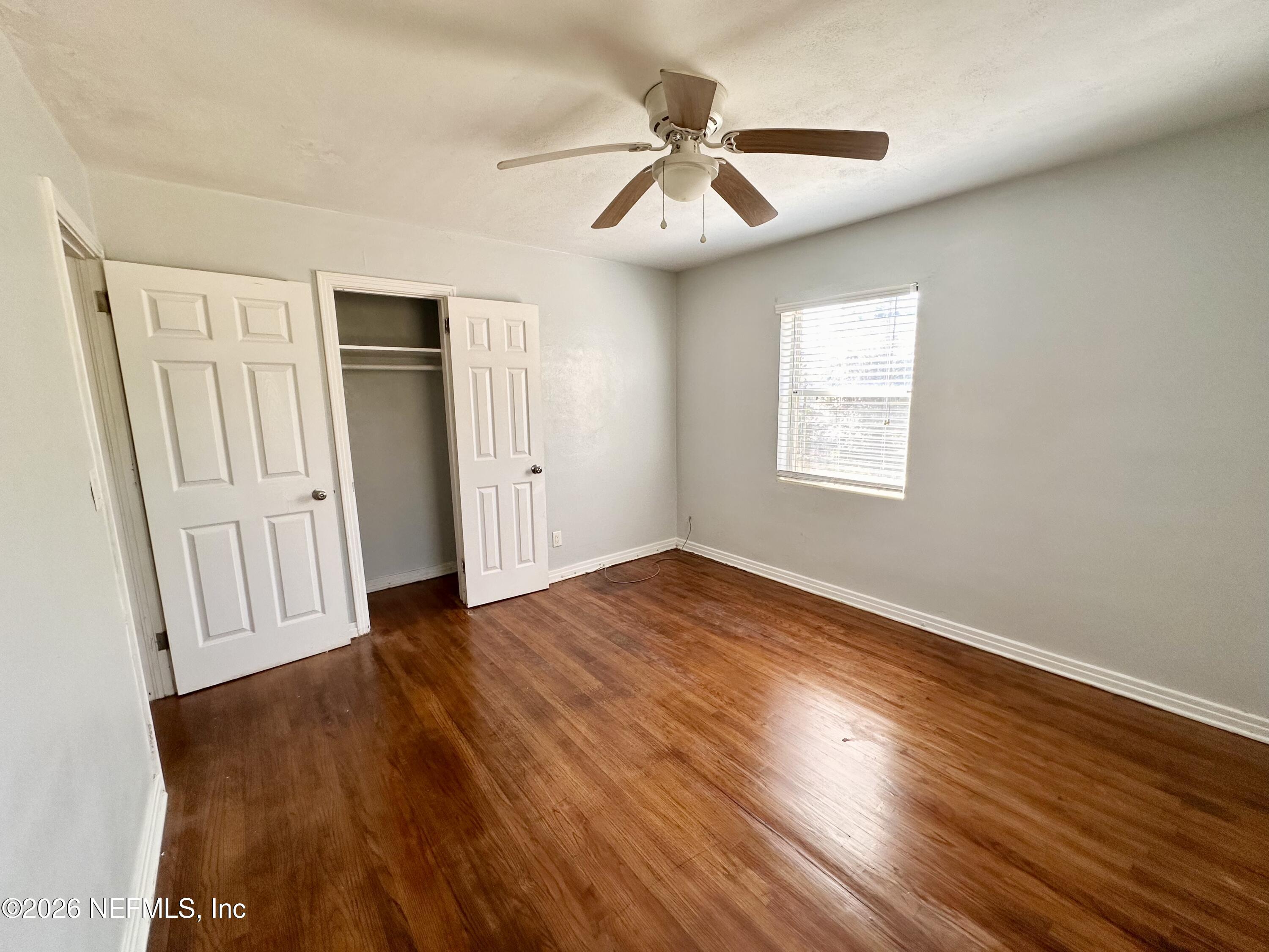 3638 Jammes Road Jacksonville, FL 32210 - Photo 18 of 31 a view of empty room with wooden floor and fan