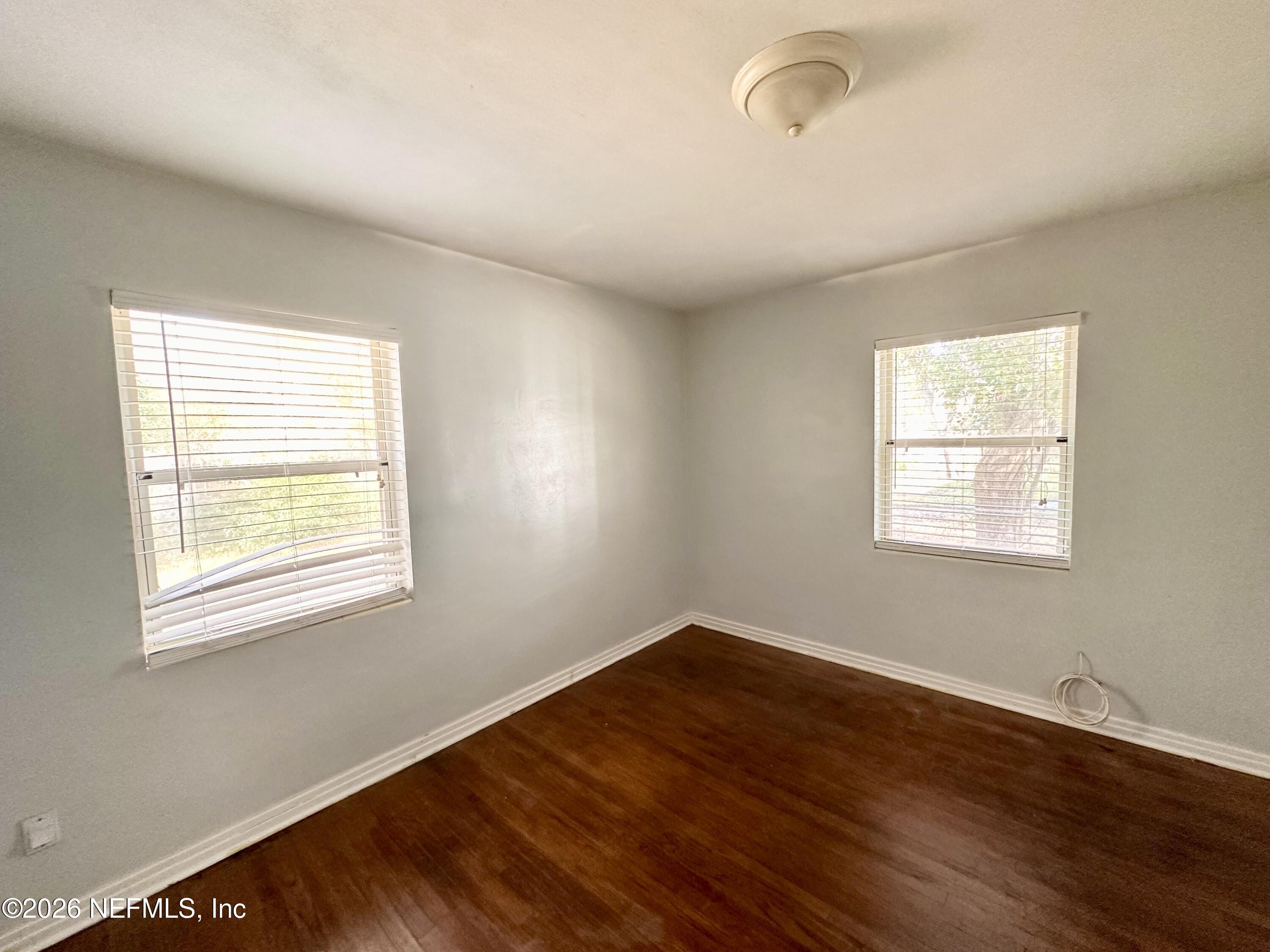 3638 Jammes Road Jacksonville, FL 32210 - Photo 21 of 31 a big room with wooden floor and windows