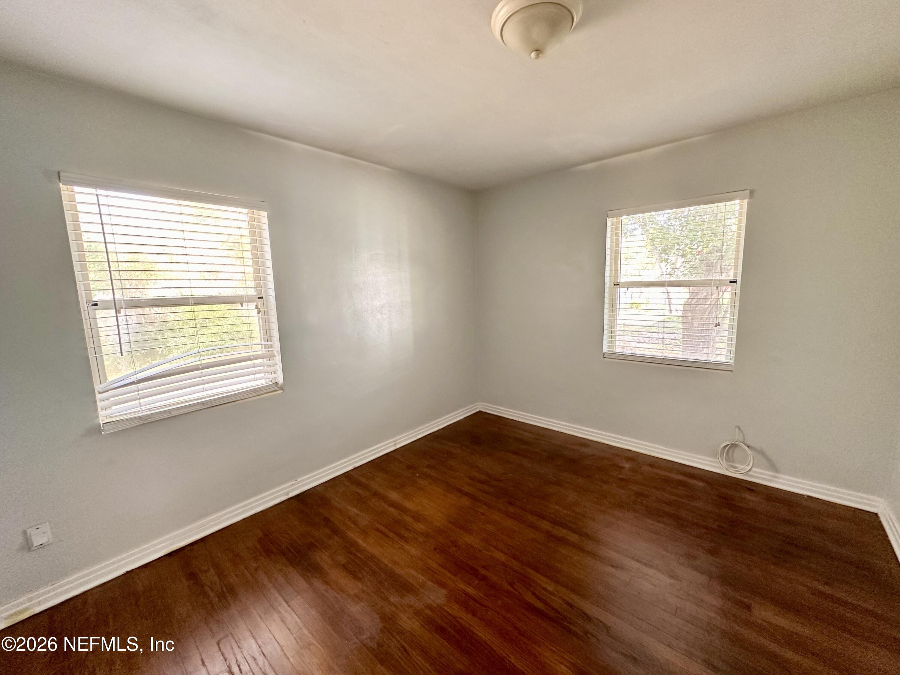 3638 Jammes Road Jacksonville, FL 32210 - Photo 29 of 31 a view of an empty room with wooden floor and a window