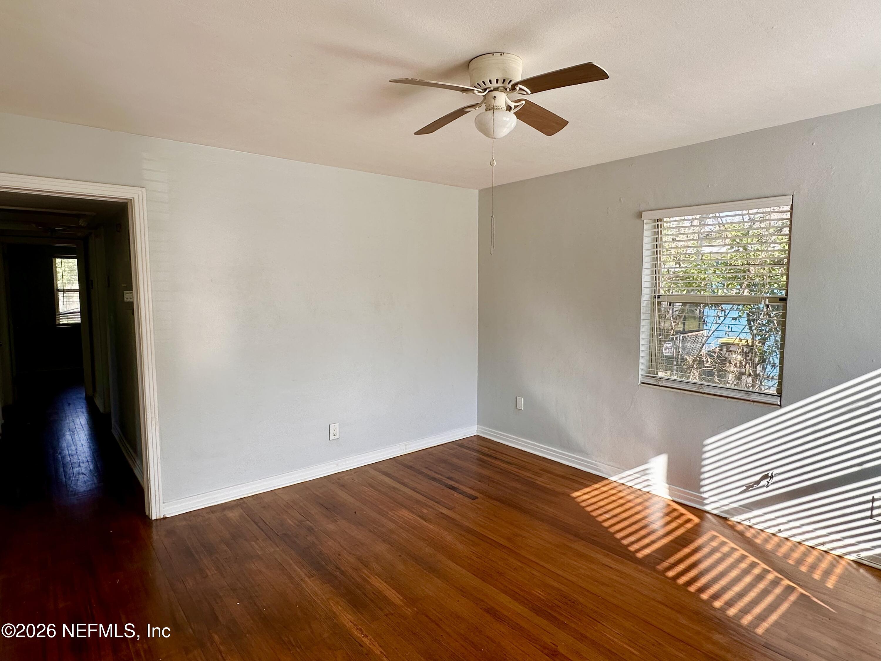 3638 Jammes Road Jacksonville, FL 32210 - Photo 5 of 31 wooden floor in an empty room with a window
