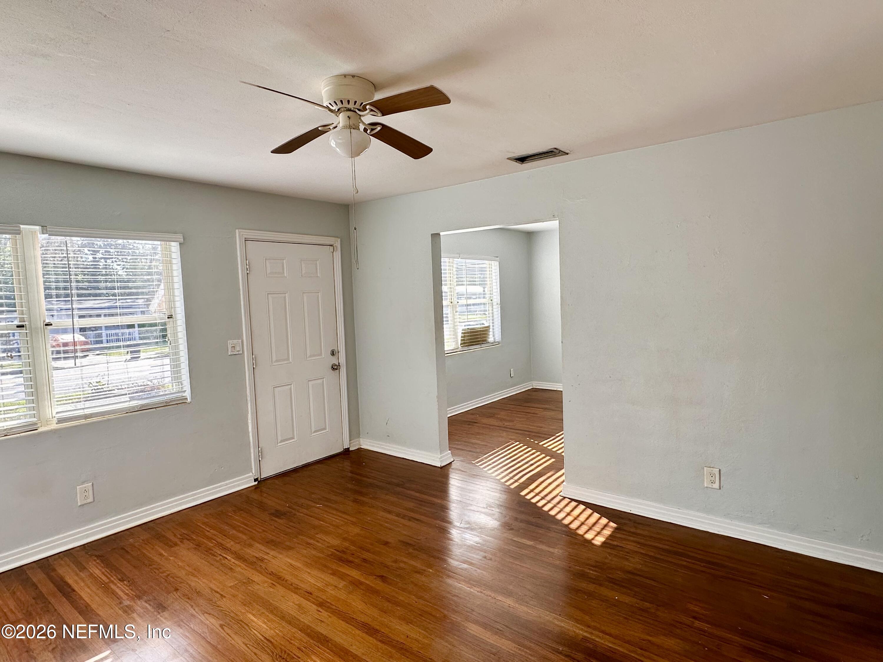 3638 Jammes Road Jacksonville, FL 32210 - Photo 8 of 31 a view of empty room with wooden floor and fan